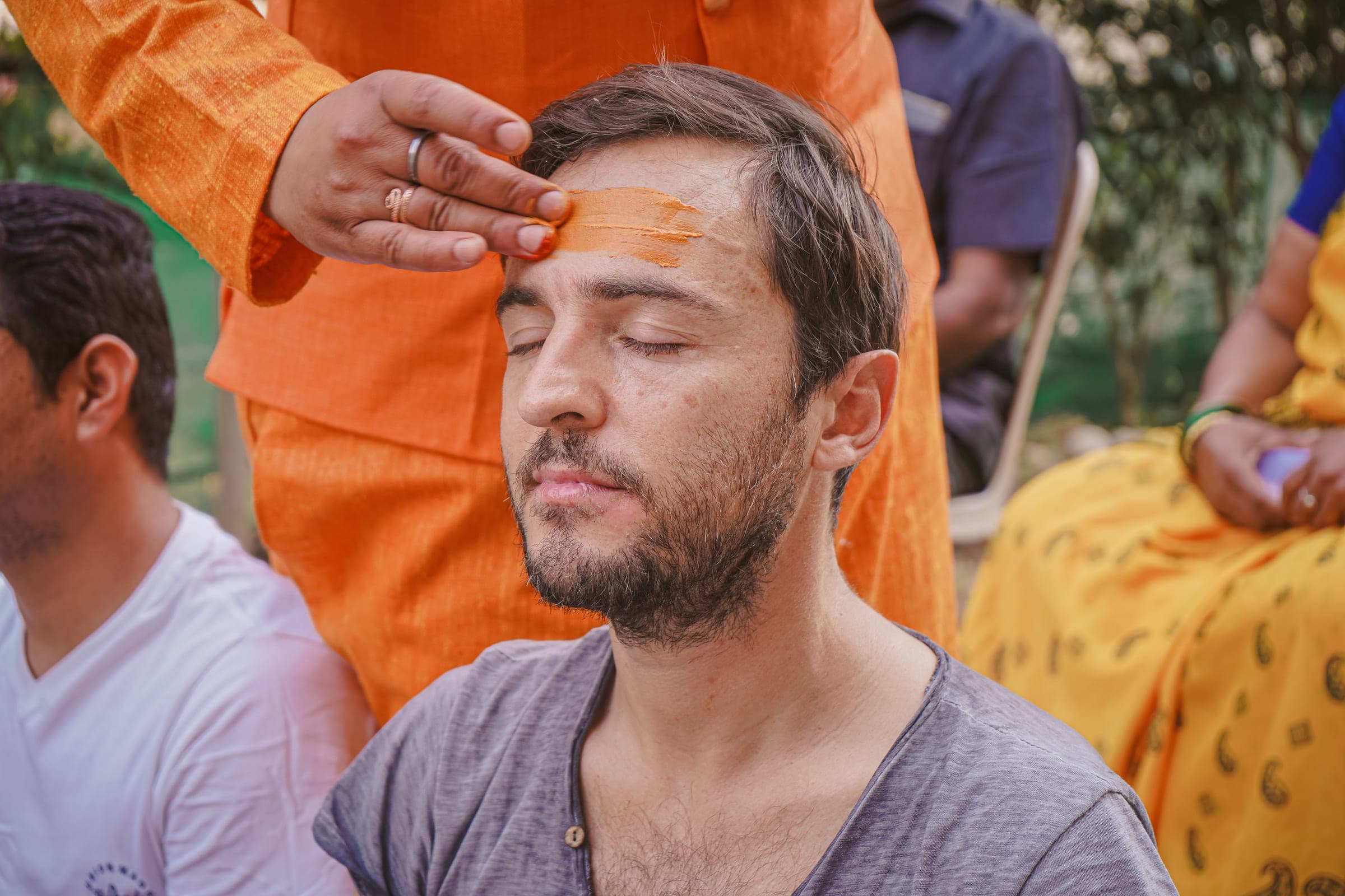 Receiving the tilak with eyes closed