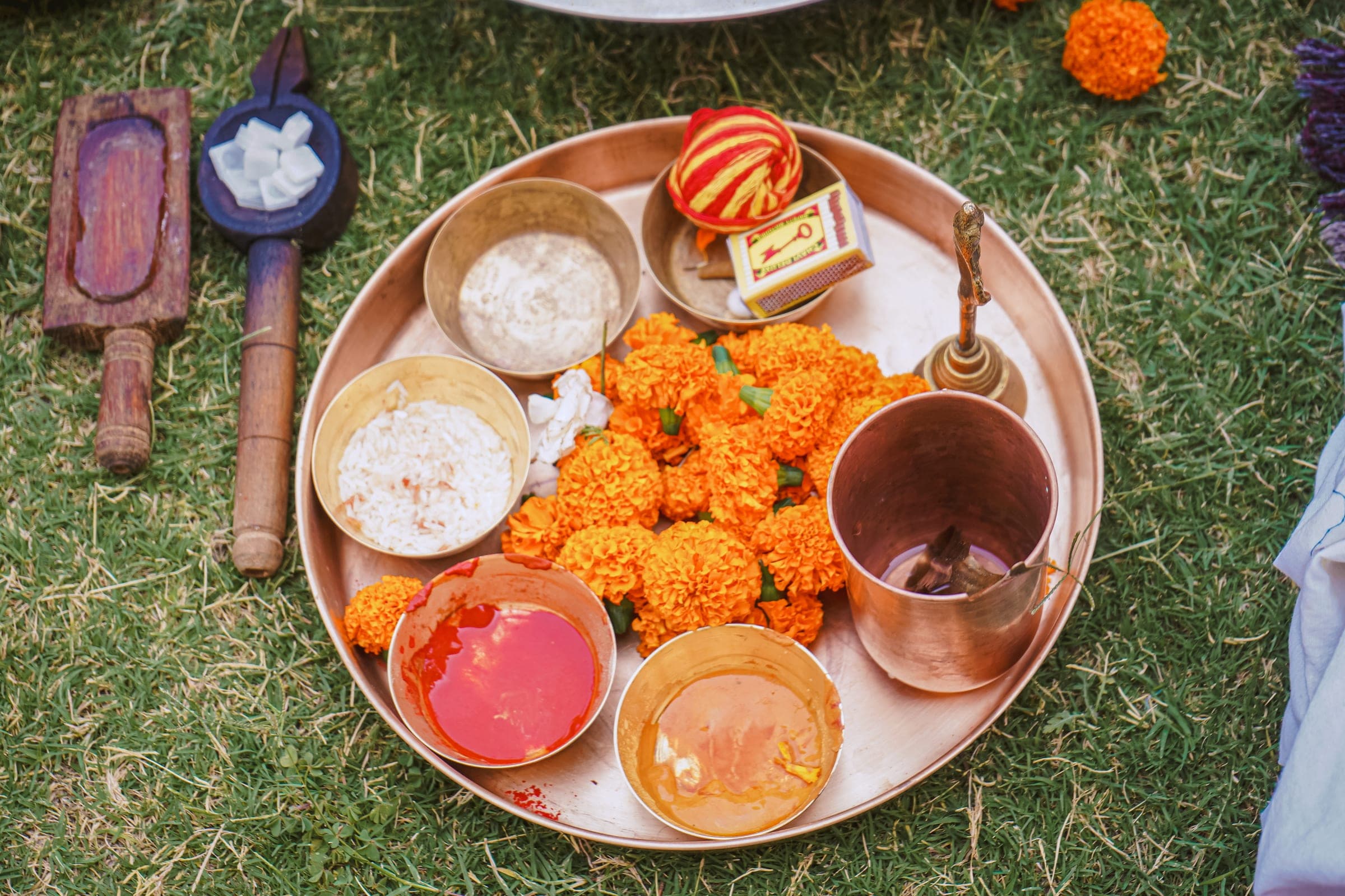 The puja plate laid out on the grass