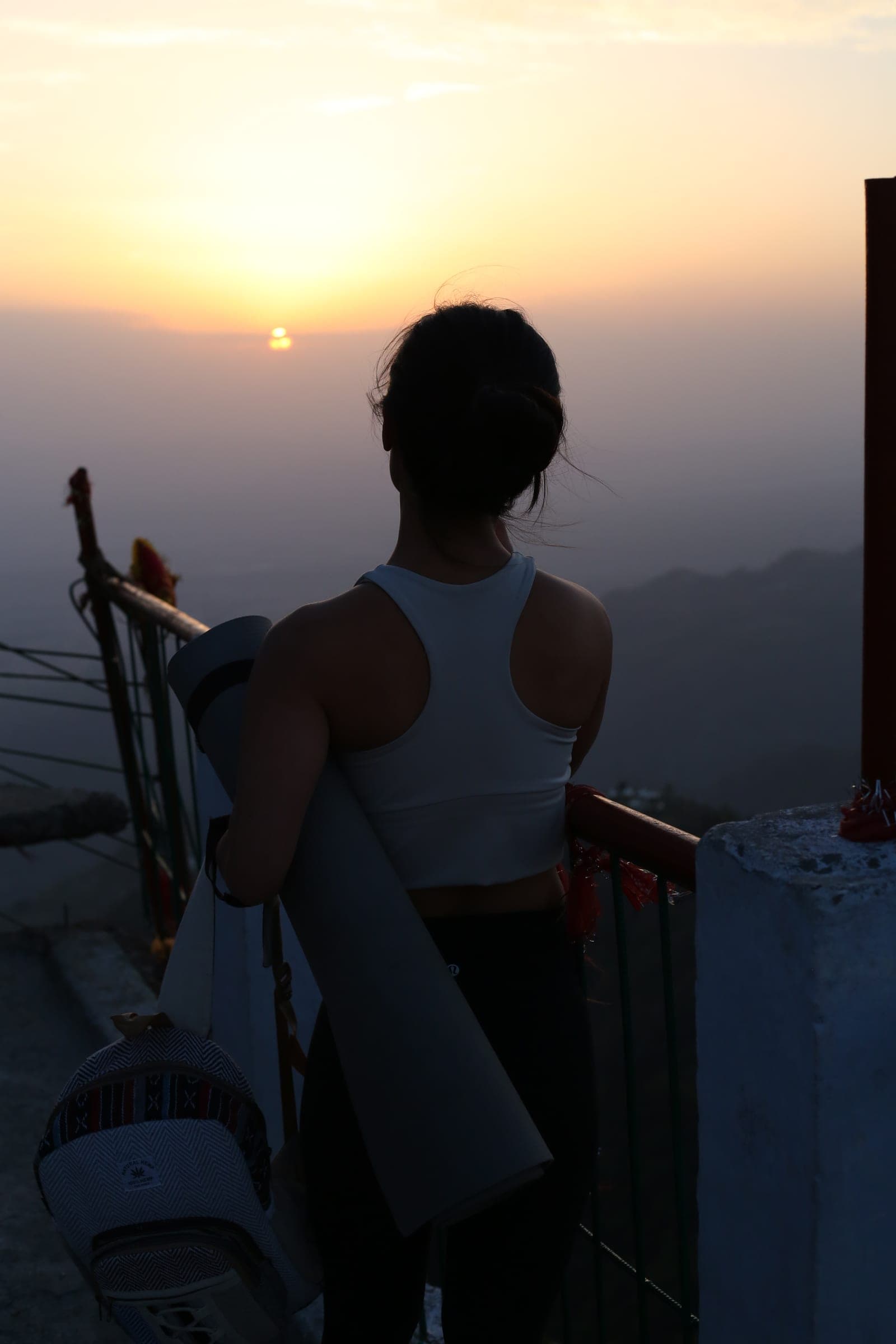 Carrying a mat out into the sunrise