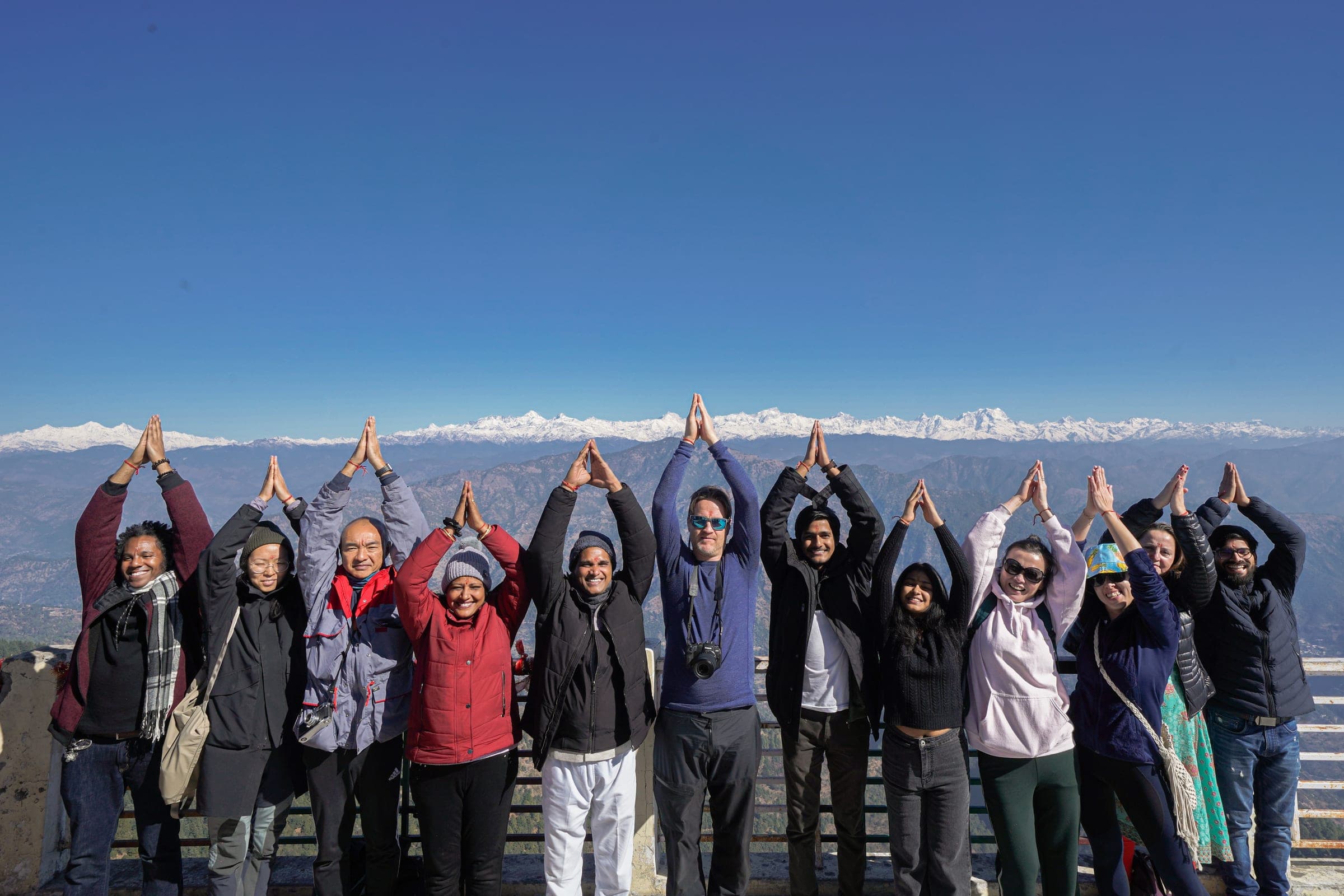 Namaste with the peaks behind
