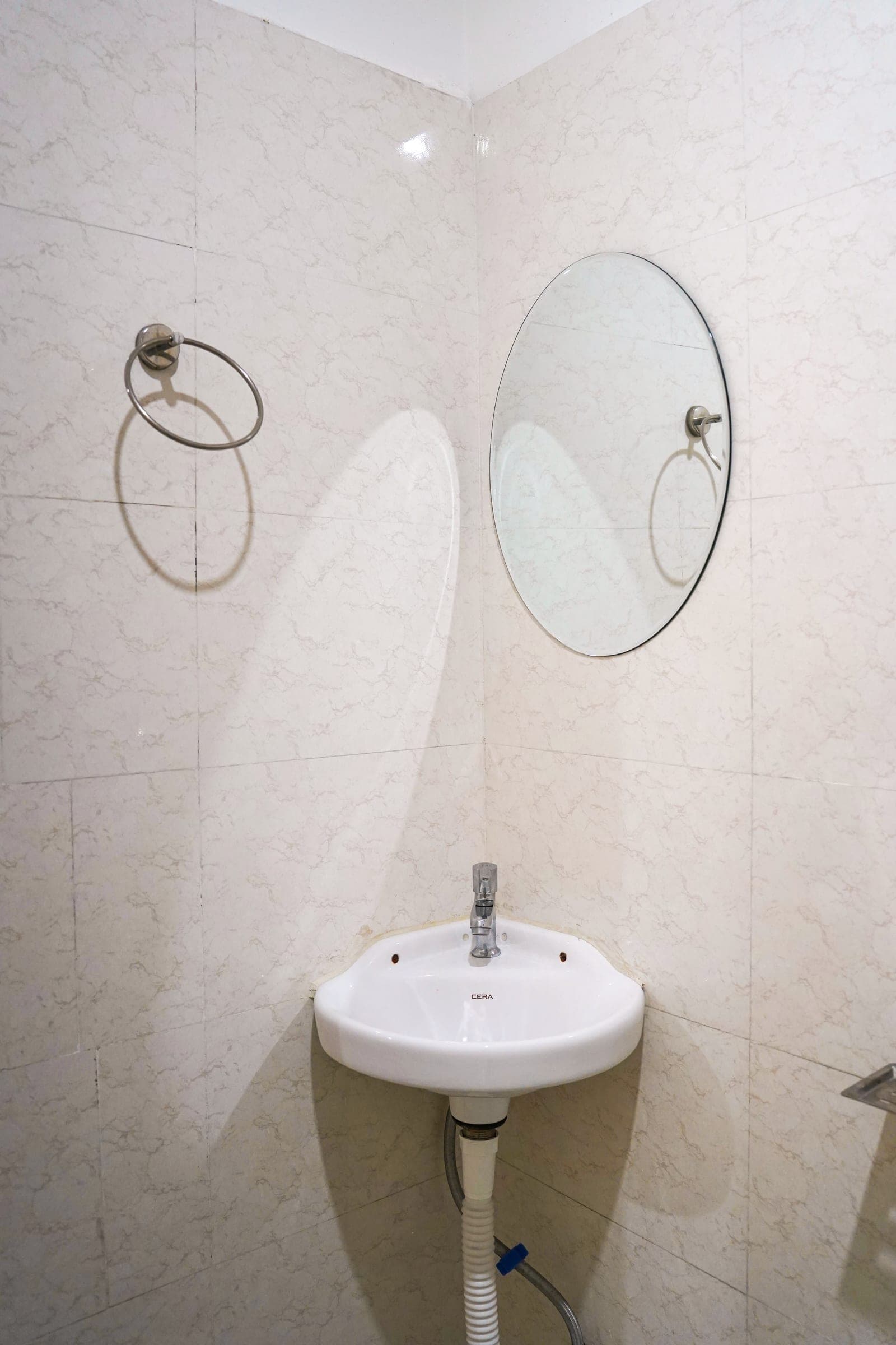 The corner basin and mirror in an attached bathroom