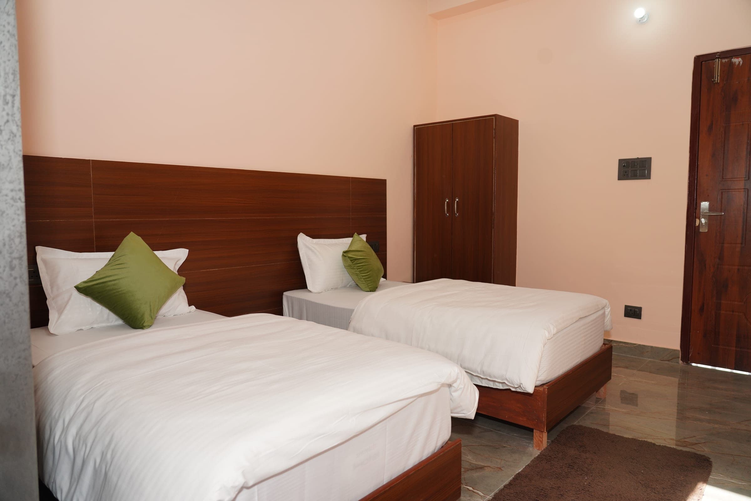 A naturally ventilated sharing room, with the wardrobe by the door