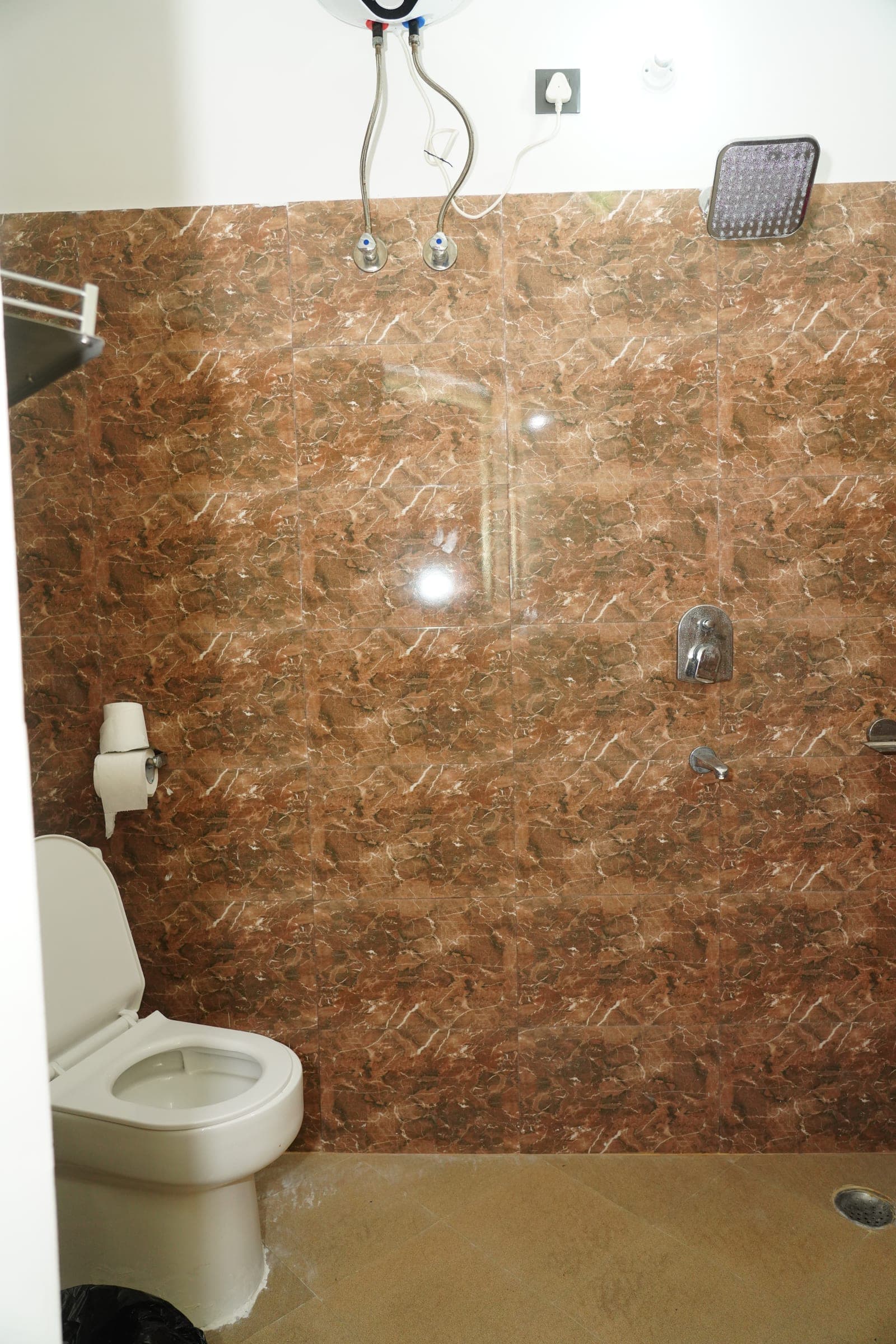 The water heater above the shower in an attached bathroom