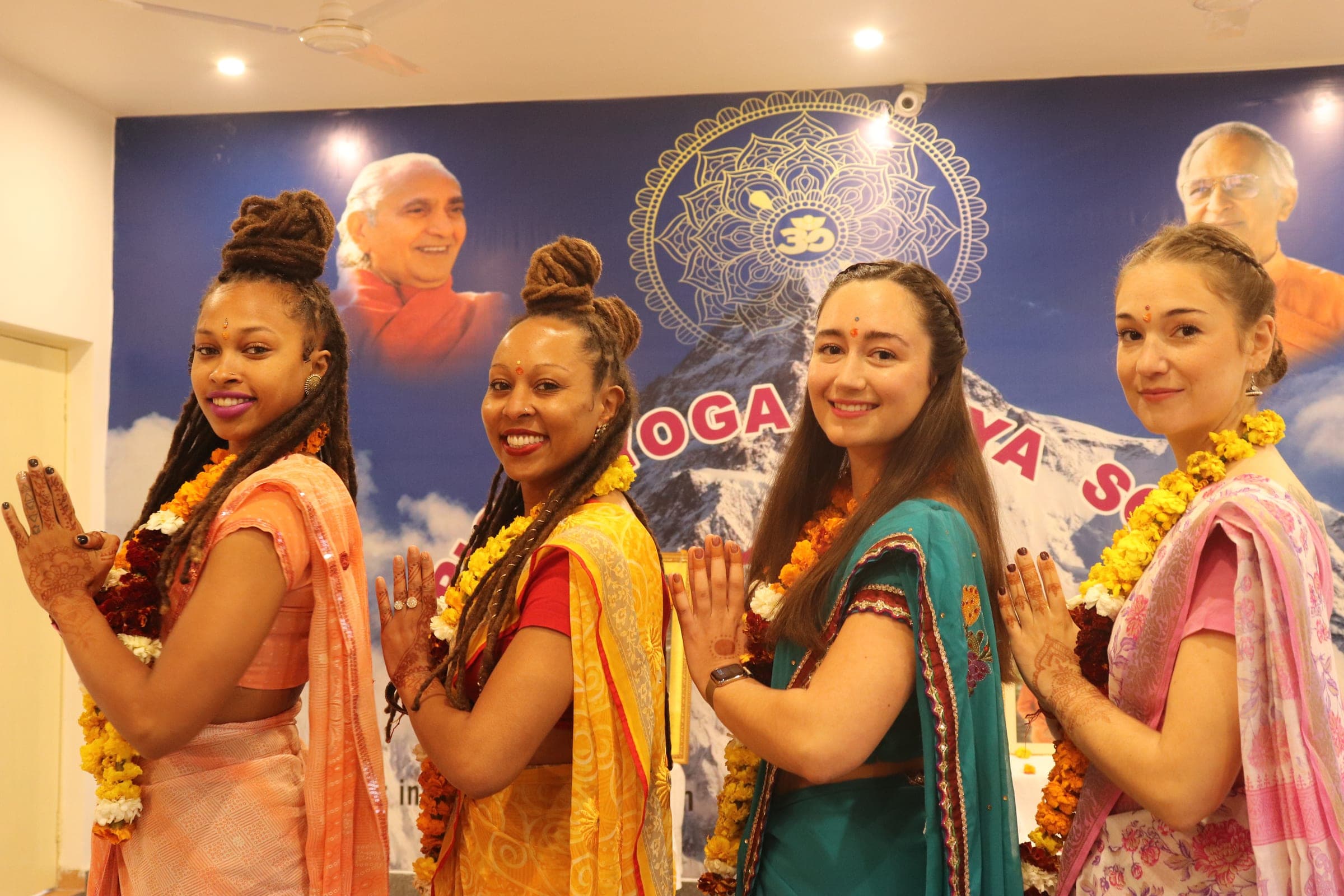 Four students in saris for the closing ceremony