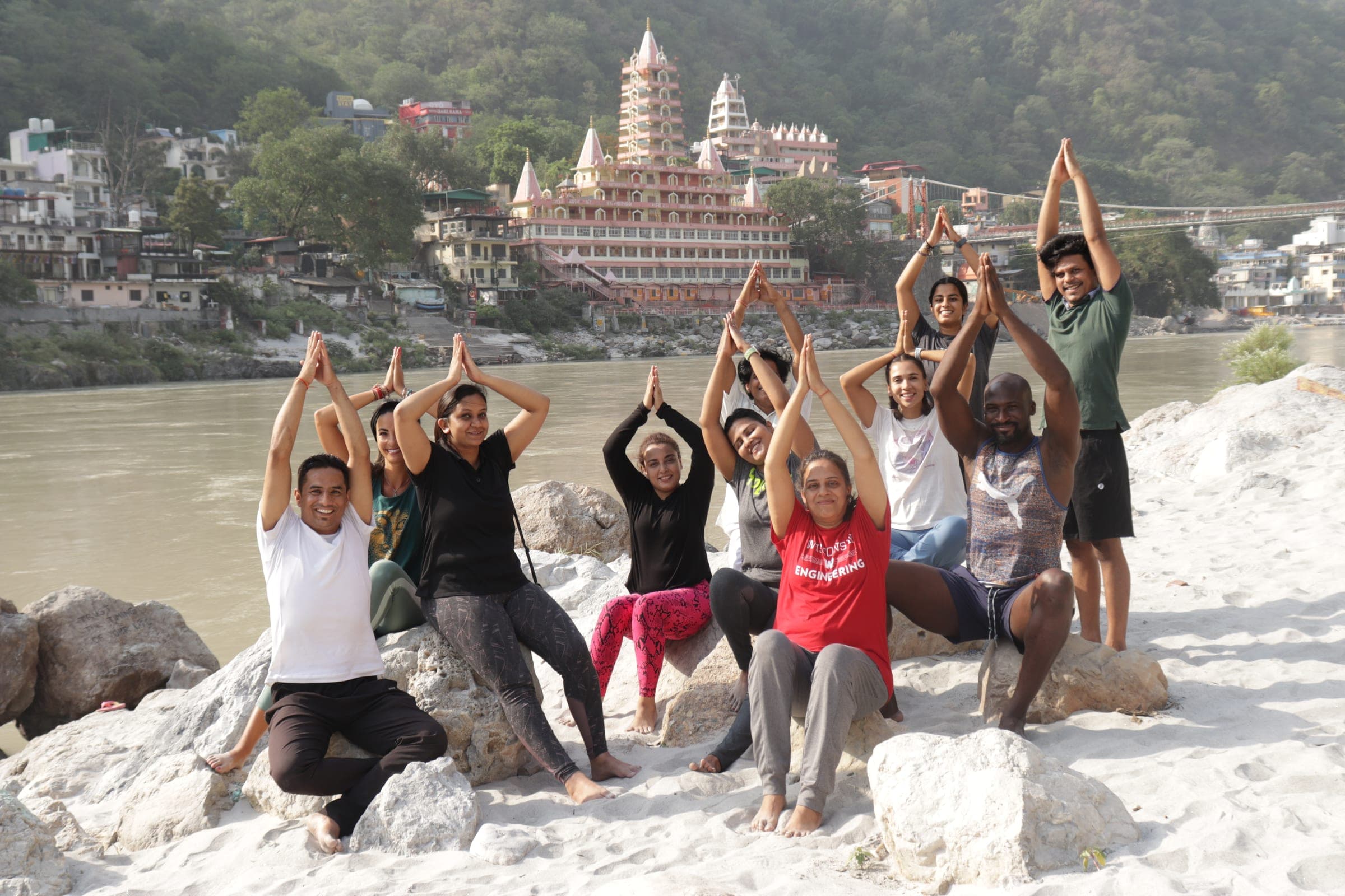 Arms up on the rocks with the temple behind