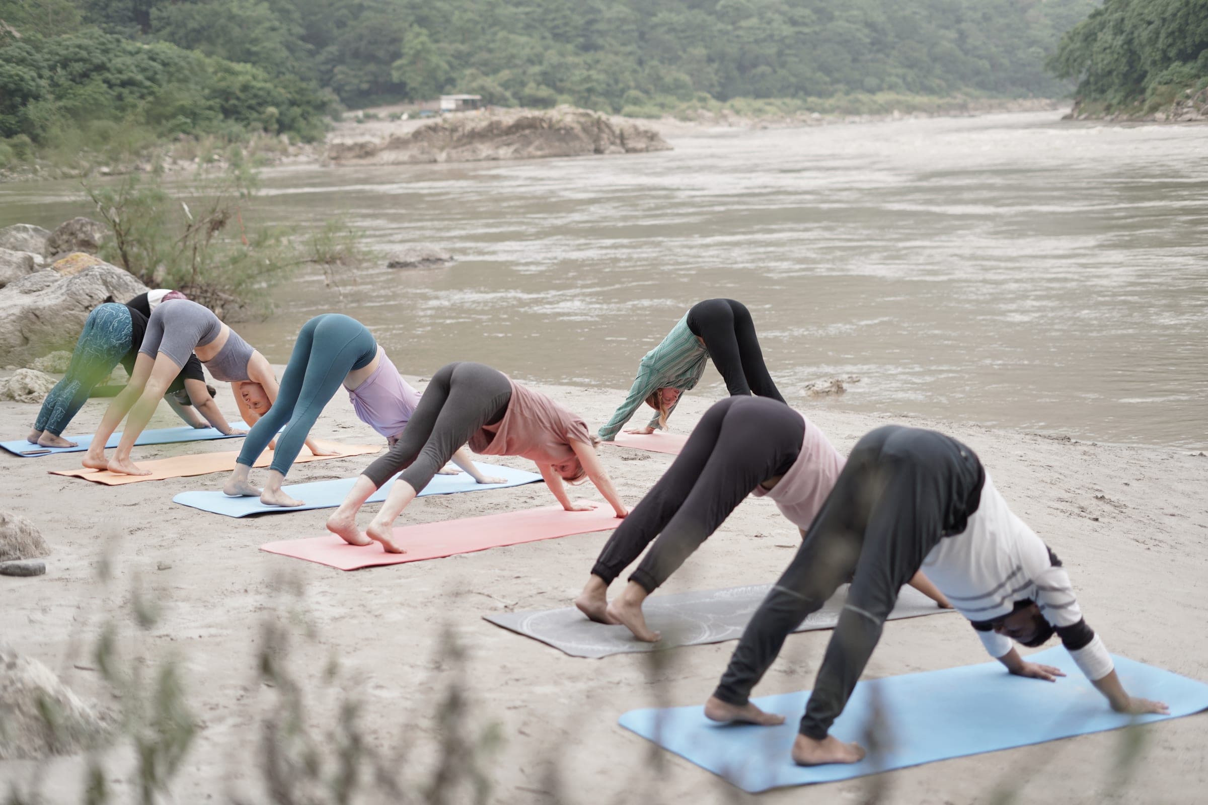 Downward dog along the riverbank