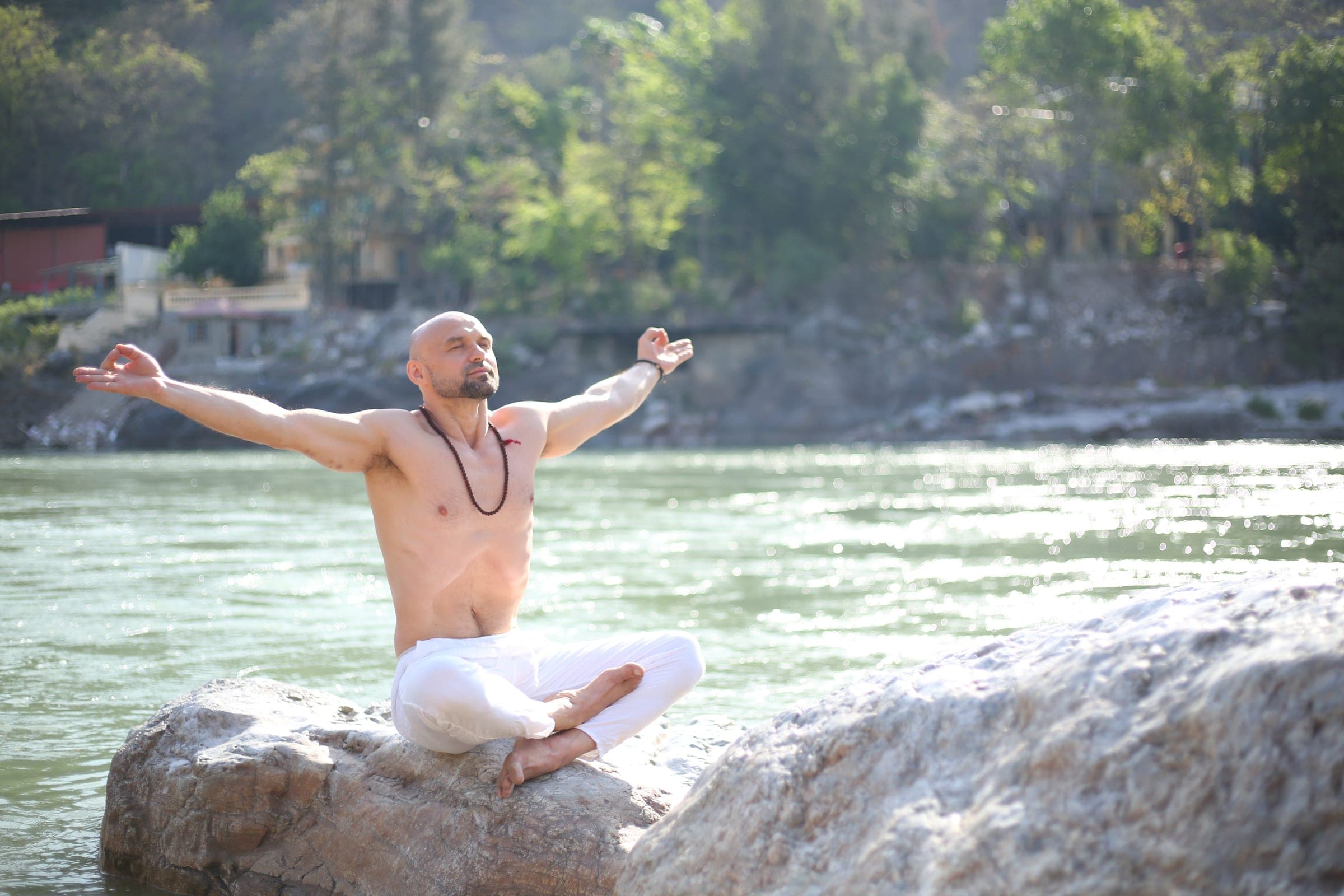 Seated with open arms on the rock